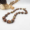 Pearl necklace in a drop of chocolate-toned rock